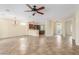 Expansive living area with open flow to kitchen, featuring tile floors, and ceiling fan at 2489 Black River Falls Dr, Henderson, NV 89044