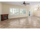 Bright living room features neutral paint, ceiling fan, natural light and a fireplace at 2489 Black River Falls Dr, Henderson, NV 89044