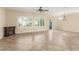 Bright and airy living room features tile floors, fireplace and ample windows with plantation shutters at 2489 Black River Falls Dr, Henderson, NV 89044