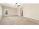 Spacious living room with carpet, ceiling fan, and natural light from windows and glass door at 2489 Black River Falls Dr, Henderson, NV 89044