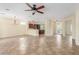 Open-concept living room with tile floors flowing to the kitchen featuring a breakfast bar at 2489 Black River Falls Dr, Henderson, NV 89044