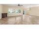 Bright living room featuring tile floors, plantation shutters, and a cozy electric fireplace at 2489 Black River Falls Dr, Henderson, NV 89044
