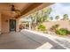 This covered patio is the perfect retreat, featuring a ceiling fan and a view of the landscaped backyard at 2489 Black River Falls Dr, Henderson, NV 89044