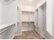 Bright, walk-in closet with built-in shelving and tile floors at 2489 Black River Falls Dr, Henderson, NV 89044