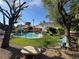 This backyard features a pool, fire pit, and lush green lawn at 2807 Camelback Ln, Henderson, NV 89074