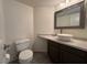 This bathroom features a white toilet, sink, mirror, and neutral wall color at 2807 Camelback Ln, Henderson, NV 89074