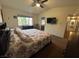 Bedroom showcasing a floral-patterned bedspread, natural light, and a glimpse into the hallway at 2807 Camelback Ln, Henderson, NV 89074