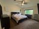 Cozy bedroom featuring a floral-patterned bedspread and a ceiling fan for comfortable living at 2807 Camelback Ln, Henderson, NV 89074