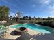 Inviting backyard pool with a built-in fire pit offering a relaxing outdoor space for entertaining and leisure at 2807 Camelback Ln, Henderson, NV 89074