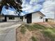 View of a single-story house with a white siding and a black accent wall and a lawn at 4186 Toronto Cir, Las Vegas, NV 89121