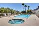Community pool and spa surrounded by lounge chairs and well-kept landscaping, perfect for relaxation and recreation at 523 Crimson View Pl, Las Vegas, NV 89144