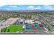 Aerial shot of a school with colorful playgrounds, sports courts, and well-maintained green spaces, set against a mountain backdrop at 6536 Castor Tree Way, Las Vegas, NV 89108