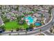 Aerial view showcasing a community pool, tennis courts, green spaces, and well-maintained landscaping in a residential area at 6536 Castor Tree Way, Las Vegas, NV 89108