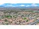 Expansive aerial view of a Las Vegas community featuring numerous homes and a breathtaking mountain range backdrop at 6536 Castor Tree Way, Las Vegas, NV 89108