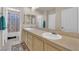 Bathroom featuring double sinks set in tile counters, and neutral fixtures for convenience at 6536 Castor Tree Way, Las Vegas, NV 89108