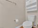 Simple bathroom with toilet, cabinet, towel rack, and tile flooring at 6536 Castor Tree Way, Las Vegas, NV 89108