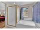 Bright bathroom featuring a bathtub, shower, and a window with natural light at 6536 Castor Tree Way, Las Vegas, NV 89108