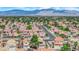 Overview of a well-maintained neighborhood with lush greenery and beautiful mountain views at 6536 Castor Tree Way, Las Vegas, NV 89108