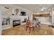 View of the dining room with fireplace and open access to the kitchen and staircase at 6536 Castor Tree Way, Las Vegas, NV 89108
