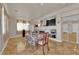 Open-concept dining room with tile flooring, fireplace, and view of the entryway at 6536 Castor Tree Way, Las Vegas, NV 89108