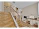 Bright entryway features tile flooring, staircase with metal railing, and a view of the fireplace at 6536 Castor Tree Way, Las Vegas, NV 89108