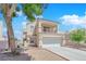 Charming two-story home featuring a balcony, two-car garage, and landscaped front yard at 6536 Castor Tree Way, Las Vegas, NV 89108