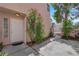 Home's charming front entrance with garden and concrete walk way at 6536 Castor Tree Way, Las Vegas, NV 89108