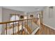 Hallway features hardwood flooring, staircase with railing, and view of the living room below at 6536 Castor Tree Way, Las Vegas, NV 89108
