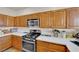 Kitchen features stainless steel appliances, white countertops and wooden cabinets at 6536 Castor Tree Way, Las Vegas, NV 89108