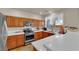 Kitchen featuring modern appliances, light countertops, and wooden cabinetry at 6536 Castor Tree Way, Las Vegas, NV 89108