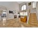 Bright living room with tile floors, a fireplace, and a staircase leading to the upper level at 6536 Castor Tree Way, Las Vegas, NV 89108