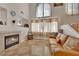 Comfortable living space featuring a fireplace, tile flooring, and an open layout at 6536 Castor Tree Way, Las Vegas, NV 89108