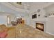 Spacious living area with a fireplace, tile floors, staircase and views to upper level at 6536 Castor Tree Way, Las Vegas, NV 89108