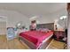Comfortable bedroom is furnished with a king-sized bed, hardwood flooring, and soft lighting for relaxation and restful sleep at 6536 Castor Tree Way, Las Vegas, NV 89108