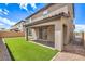 Inviting backyard with lush artificial grass, covered patio, and brick accents, perfect for outdoor relaxation and entertaining at 89 Oratorio Dr, Henderson, NV 89015