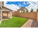 Private backyard featuring manicured artificial turf, gravel accents, and a covered patio, great for outdoor activities at 89 Oratorio Dr, Henderson, NV 89015