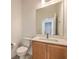 Stylish powder bathroom features a modern vanity with a framed mirror above the sink at 89 Oratorio Dr, Henderson, NV 89015