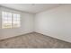 Bedroom features neutral carpet, one window, and white walls at 89 Oratorio Dr, Henderson, NV 89015