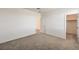 Spacious bedroom with neutral walls and plush carpet, complemented by a bright walk-in closet at 89 Oratorio Dr, Henderson, NV 89015