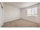 Neutral-toned bedroom featuring a large window that lets in natural sunlight at 89 Oratorio Dr, Henderson, NV 89015