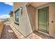 Inviting front entrance featuring brick pavers, a decorative green front door, and exterior lighting at 89 Oratorio Dr, Henderson, NV 89015