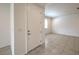Spacious foyer featuring tile flooring, a white front door, and views of the bright interior at 89 Oratorio Dr, Henderson, NV 89015