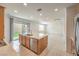 Open kitchen showcases stainless steel appliances and island with access to the backyard at 89 Oratorio Dr, Henderson, NV 89015