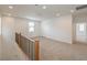 Upstairs living area featuring wood railing and carpet floors at 89 Oratorio Dr, Henderson, NV 89015