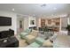 Bright, open-concept living room showcasing stylish furnishings and seamless flow to the modern kitchen and dining area at 89 Oratorio Dr, Henderson, NV 89015