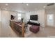 Bright living room with a brown sofa, modern TV, and neutral decor for relaxation and entertainment at 89 Oratorio Dr, Henderson, NV 89015
