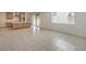 Bright living area with tile flooring, leads to a kitchen with stainless steel appliances and access to the backyard at 89 Oratorio Dr, Henderson, NV 89015