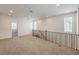 Bright loft area with neutral carpet, natural light and a wood and metal railing at 89 Oratorio Dr, Henderson, NV 89015