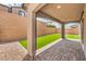 Inviting covered patio features brick pavers and a lush artificial lawn at 89 Oratorio Dr, Henderson, NV 89015