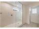 Walk-in shower with white tiles, glass door, built in seat, and a tiled floor at 89 Oratorio Dr, Henderson, NV 89015